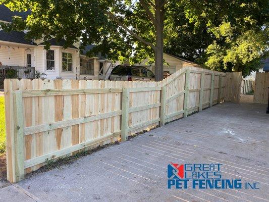 6'H with a transition to 4'H Premium Pressure Treated Pine Dog Ear Fence in New Era, MI.