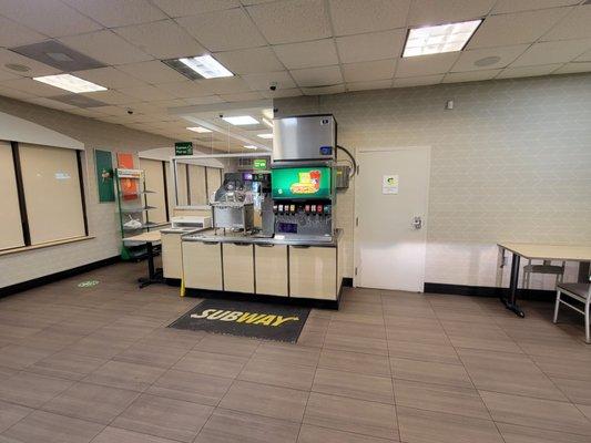 View from front door. Looking at soda machine and part of dining room.