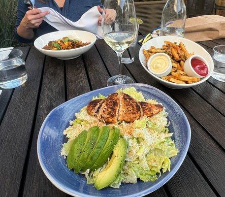 Caesar salad with blackened chicken, vegetable curry, fries