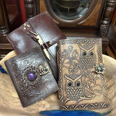 We feature many handmade items, including these hand tooled leather journals with handmade paper inside