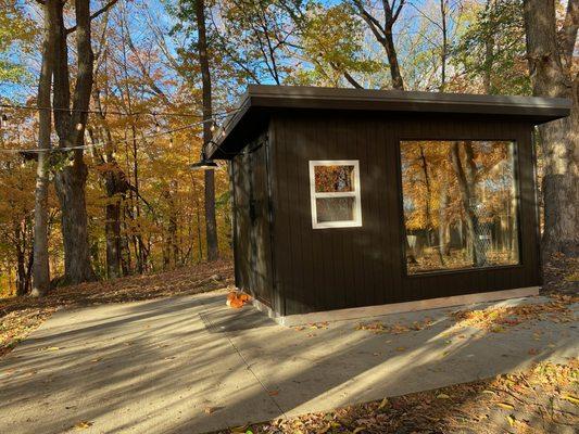 Backyard Sauna 8x12, Stained black exterior, large window in hot room