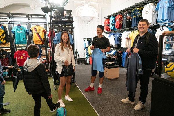 Tenzin helping a family shopping for NYCFC gear