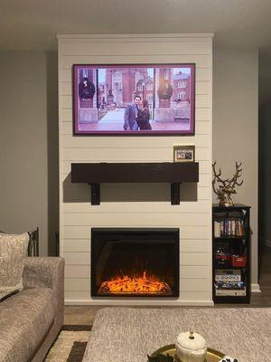 Shiplap fireplace with a custom mantle that is hollow to hide my TV box! They got everything hooked up for me too!