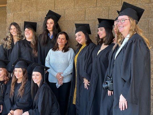 A very proud Ms. Asmi with a recent group of graduates.