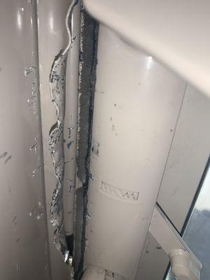 Door that was pride open by company Joe hired to fix but decided not to finish the job because Joe didn't want to pay.