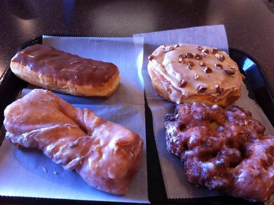 Long john, maple nut cinnamon roll, apple fritter, and something else deliciously glazed (clockwise from top left).