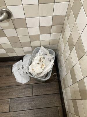 trash can full of tissue with human waste on them