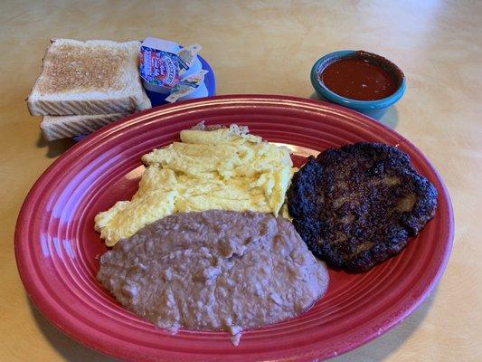 Sausage, eggs, refried beans, toast, and red chili