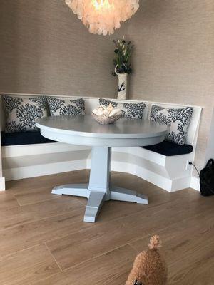 Cozy kitchen nook with custom reupholstered seating in durable Sunbrella fabric. Perfect for enjoying meals and entertaining!