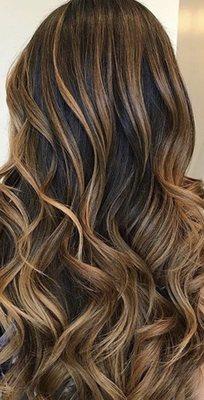 Think soft, subtle hints of blonde color placement on a slightly darker shade of hair.