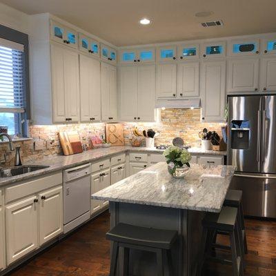 TopCoat refinished our kitchen to a white and gray solid finish. They also added upper cabinets and trim above the sink area.