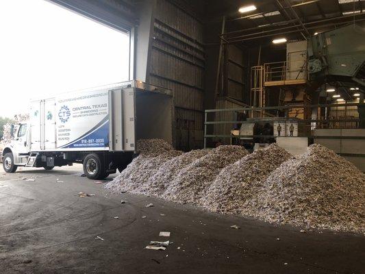 12,000 lbs of shredded paper unloaded from truck for recycling