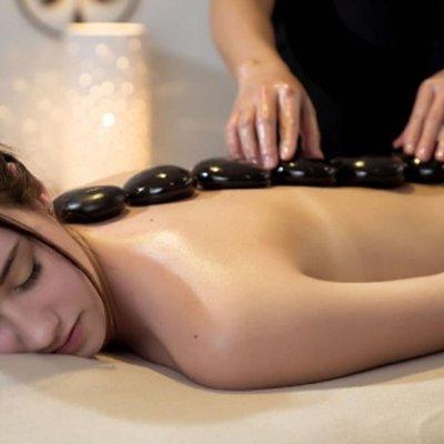 Hot Stone Therapy warms  and soothes muscles with less pressure