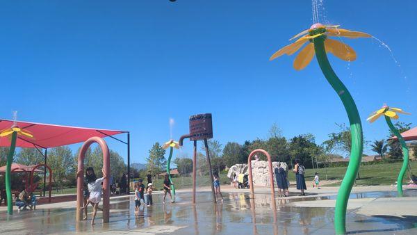 Splash pad area with the climbing boulder in the background