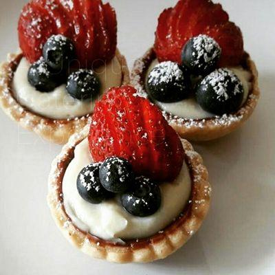 Fresh berry tarts- buttery flakypie crust with Ghirardelli chocolate ganache, vanilla bean custard, and fresh berries.