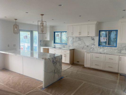 Remodeled kitchen with fabricated porcelain countertops and backsplash