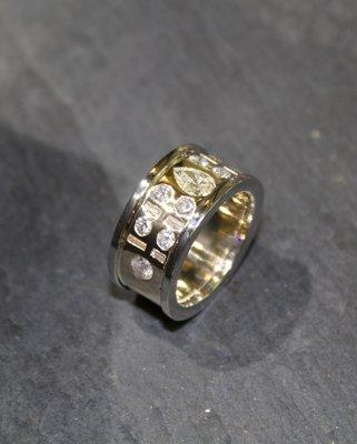 This white and yellow gold ring features diamonds from four of our customer's family members!