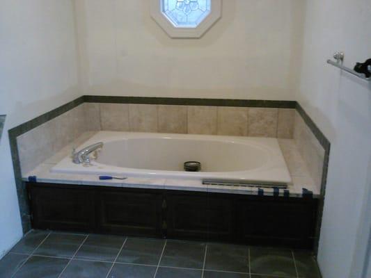 Bathroom 3 after. Marble surround, tile flooring