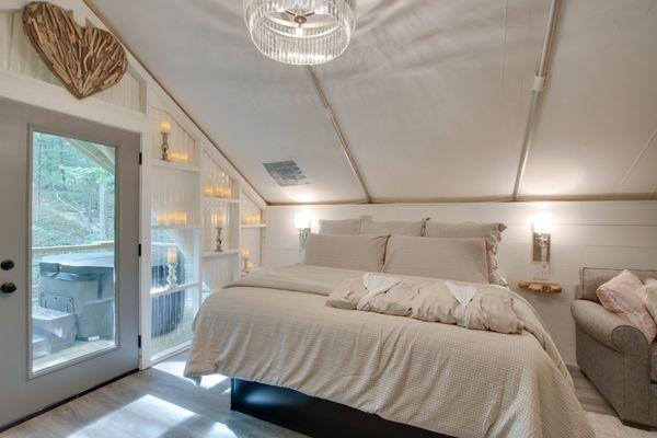 The inside of one of six on-site climage controlled glamping tents featuring private bath, kitchenette and deck.