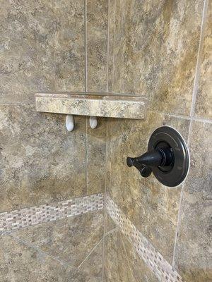 Cleaning, caulking, and sealing shower.