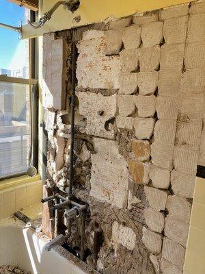 Incredible view of the faucet and pipe held in shower wall