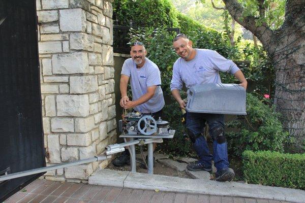 Westcoast Gate technicians repairing an electric gate operator