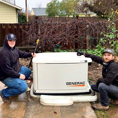 Two members of Sunset's Install team install a whole-home generator in Portland.