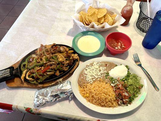 Fajitas with chicken, steak, and shrimp. Cheese dip. Chips and Salsa.