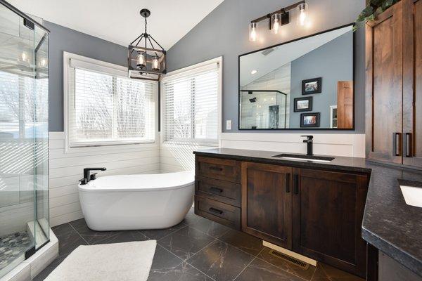 Farmhouse style masterbath with a bath tub and shower.