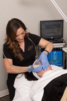 Griffin Churchwell, Aesthetician, performing a hydrating skin treatment with HydraFacial