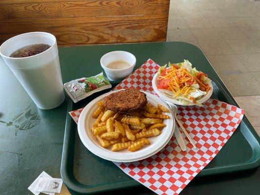 Chicken Fried Steak with French Fries and salad.