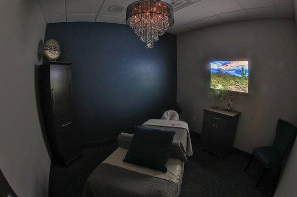 Our spa rooms are beautifully decorated with local Arizona LED photography, glass chandeliers, accent walls, electric table a...