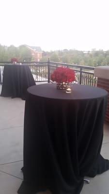 The balcony with cocktail tables for guest to mingle outdoors