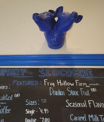 2 headed blue cow above a board describing flavors