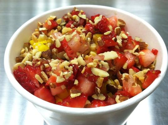 Organic oatmeal topped with strawberries and almond slices