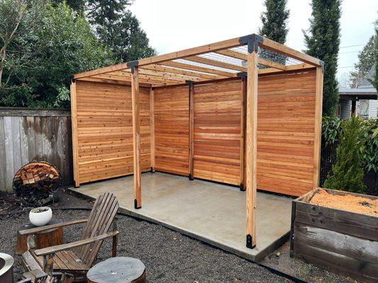 Backyard sitting covering with black hardware for a modern touch.  Built with an all cedar construction.