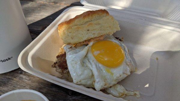 Buttermilk biscuit sandwich with fennel sausage, pimento cheese, and dill pickles