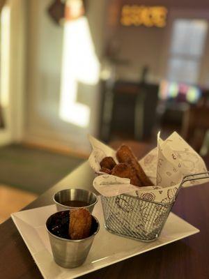 Churros with blueberry compote and caramel