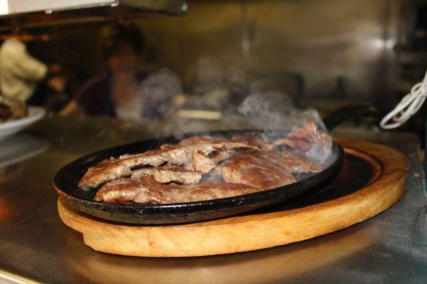 An order of carne asada served straight off the grill, cooked to your request!