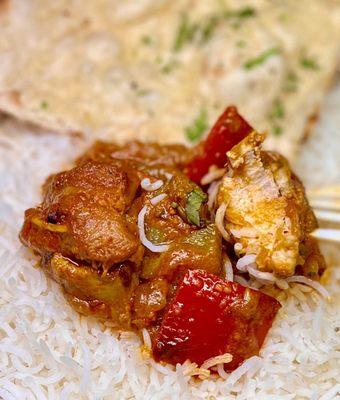 Kadai Chicken over white rice and garlic naan in back - nice chunks of chicken