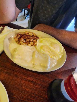 Biscuits and gravy, potatoes, eggs over easy