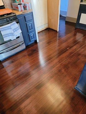 Kitchen floor that previously had very high traffic marks and even gouges from dog claws.