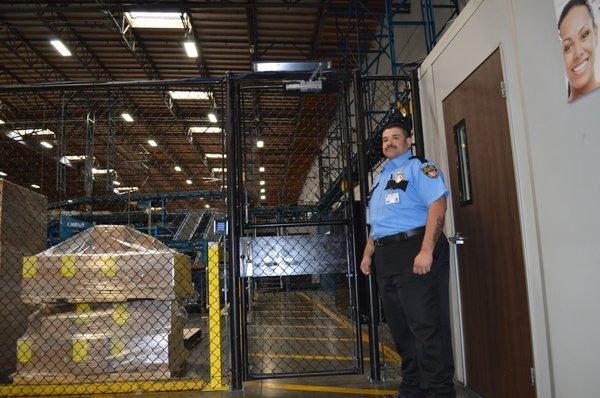 Guard in front of a warehouse