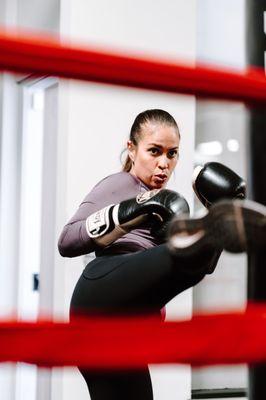 Wardance trainer Emily emphasizes athletic focus during her kickboxing classes.