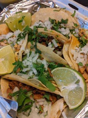 Tacos al pastor, carne asada, pollo, y chorizo con carne asada. Highly recommend al pastor.