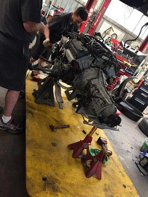 Engine replacement on a Lincoln LS - removal of the engine is actually done from the bottom of this car, along with the transmission.