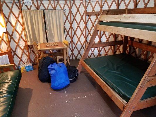 Yurt interior (10Y) looking inward from door. 2 person futon bed on left. Bunk sleeps 1 on top and 2 on bottom. (We brought the chessboard.)