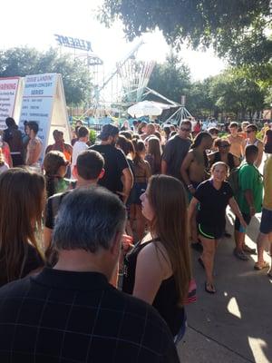 This was during my 45 min wait to purchase tickets in order to buy a drink. The white umbrella in the distance is the ticket booth.