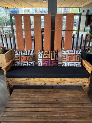 Outdoor seating area with pillows made from West African fabric. Beautiful!