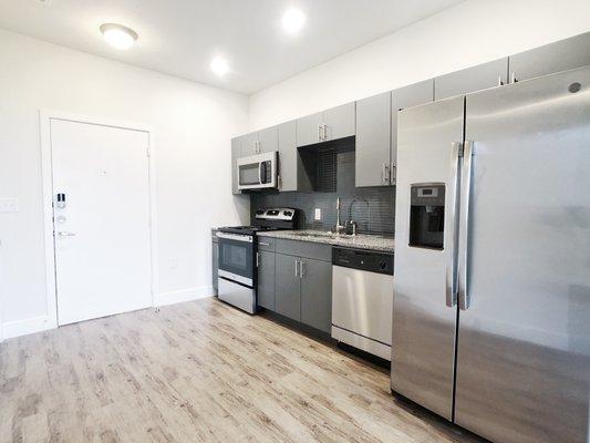 Austin apartment kitchen with gray cabinets.